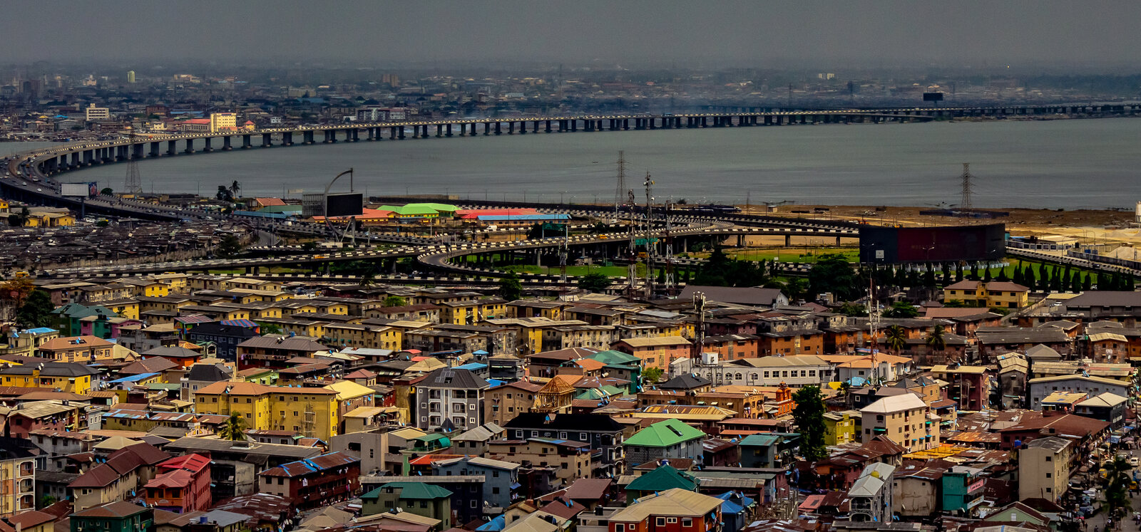 Lagos Island rooftops with the Third Mainland Bridge crossing the lagoon behind them
